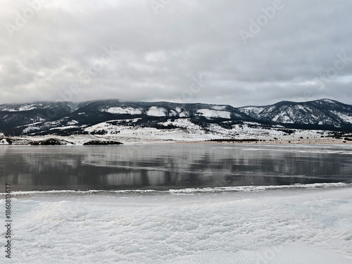 Baikal Lake in winter. Beautiful landscape with mountains reflected in ice of frozen Small Sea