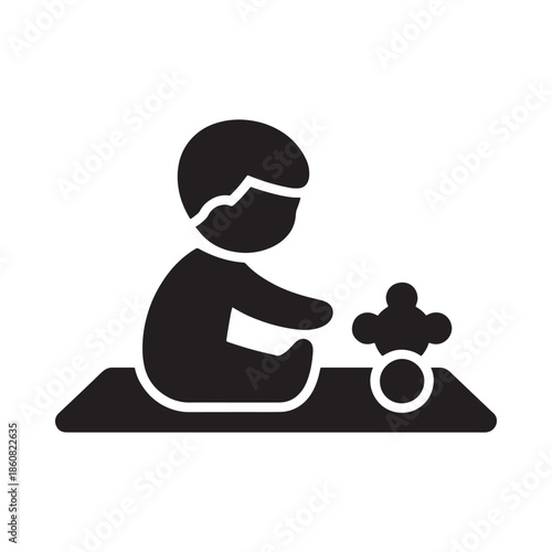 A simple black silhouette of a baby playing with a rolling toy