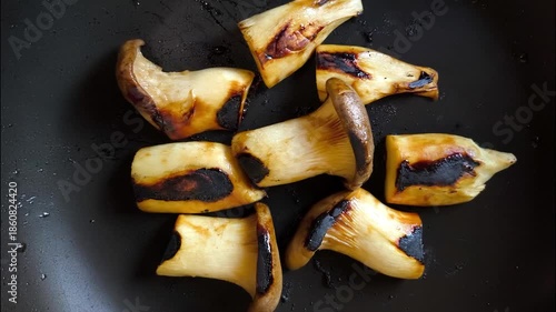 Grilling oyster mushrooms in pan, indoor Chiangmai Thailand.