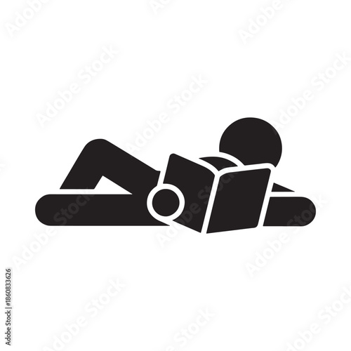 A person relaxing and reading a book in a lying down position