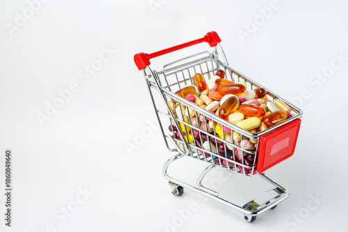 Medicinal pills and vitamins in a small shopping cart in a supermarket