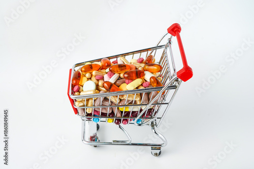 Drug store and online pharmacy concept with supermarket trolley and assorted medicine pills