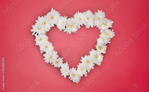 White Flowers Heart on Pink Paper Surface. File with Clipping Path.
