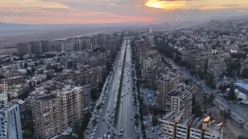 Aerial shot captures the Syrian capital at sunset, showing the city’s skyline, streets, and urban areas as daylight fades over the capital.