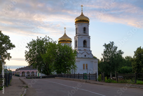 Bell tower and dome of the ancient Cathedral of the Epiphany in early July morning. Vyshny Volochek, Russia