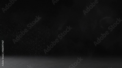 Abstract image features swirling smoke and particulate matter against a dark background