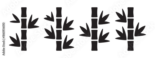 Four stylized bamboo stalks with arrow like leaves black silhouettes isolated on white background