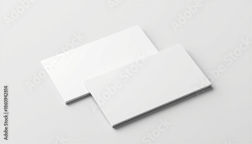 Glossy finish business card mockup in a minimalist and modern mood with two blank cards slightly overlapping on a smooth white surface