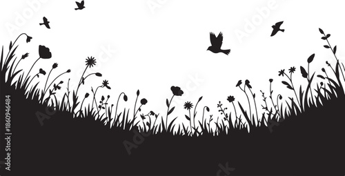 Silhouette of birds flying over a field of wildflowers