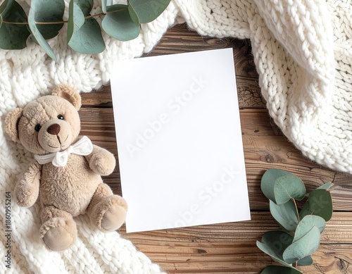Teddy, paper, blanket, eucalyptus on rustic wooden surface