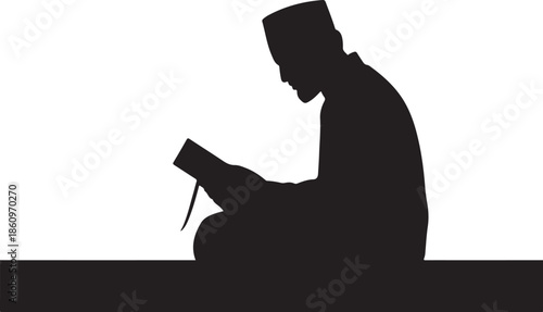 Silhouette of a person praying with a book on a table
