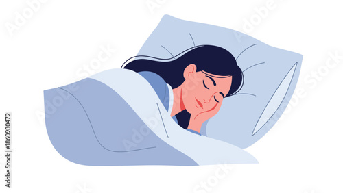 Close up portrait of a young woman sleeping peacefully in a soft bed with a blue pillow and warm blankets at night.