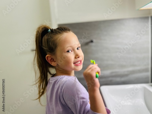 little girl brushing her teeth