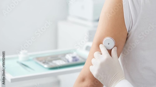 Medical professional using stethoscope on patient arm with healthcare doctor applying adhesive patch