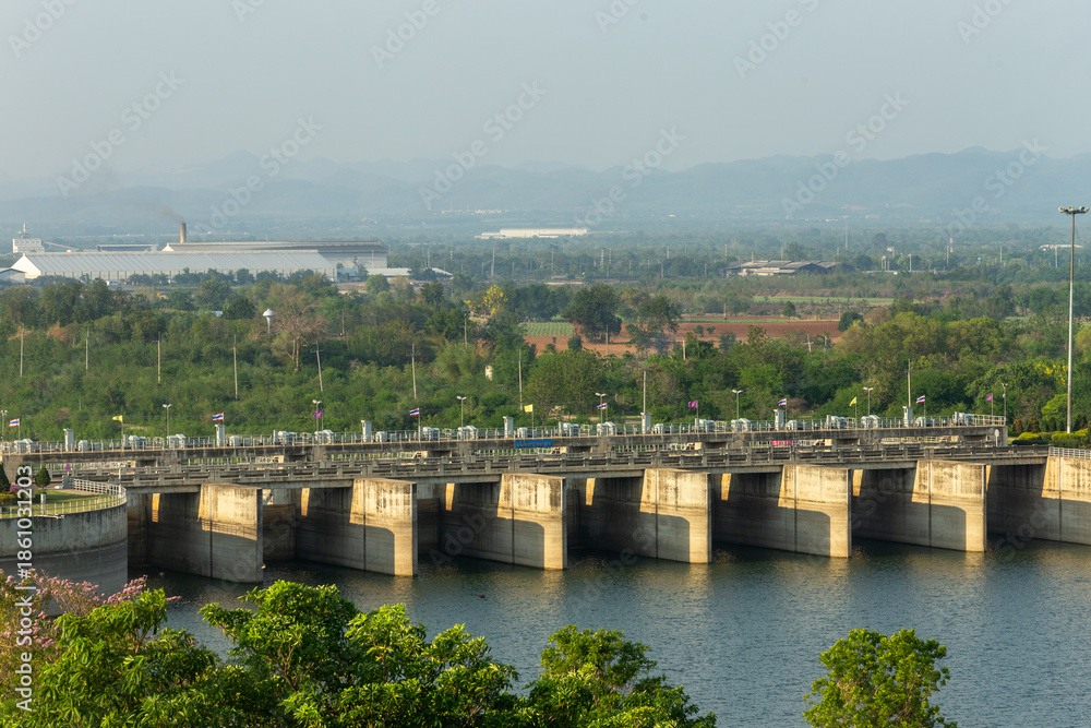 Obraz premium A panoramic view of the massive dam is striking, with stunning river scenery against a clear blue sky.