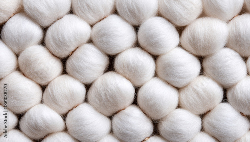 Neatly arranged white cotton balls showcasing soft, fibrous texture and round shape in a uniform pattern