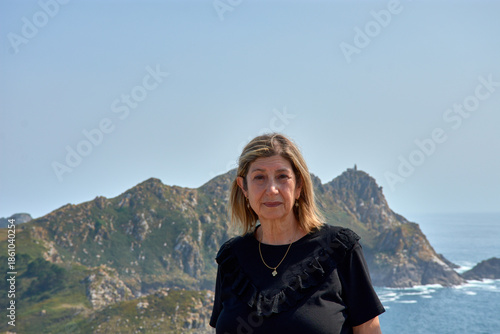 Senior woman enjoying the breathtaking views of the Cies Islands landscape.