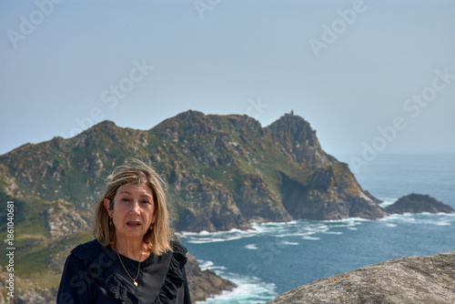 Senior woman enjoying the breathtaking views of the Cies Islands landscape.