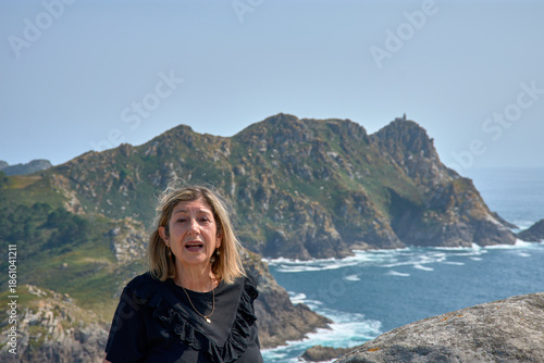 Senior woman enjoying the breathtaking views of the Cies Islands landscape.