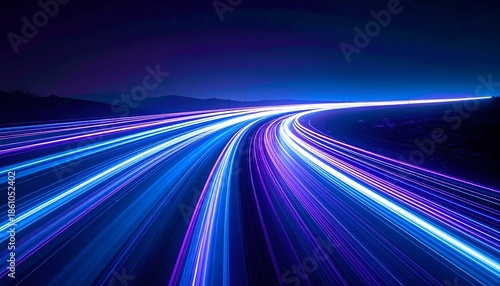 A stunning display of light trails on a dark roadway, showcasing vibrant blue and purple hues