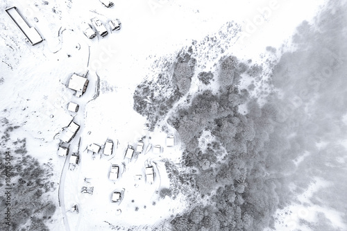 The village, the Alpine pasture and the frozen forest, Alps landscape, Valtellina, Italy