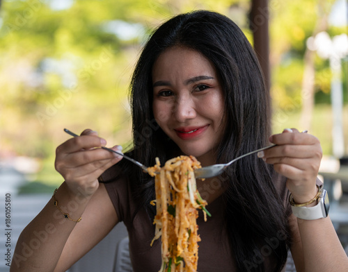 Thai Girl Smiles and Enjoys her food 