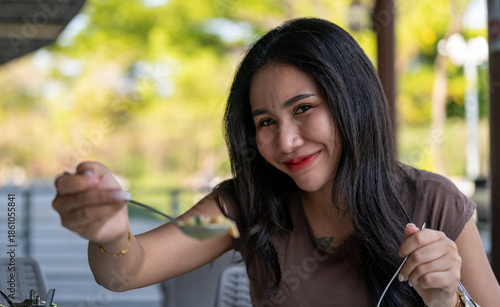 Thai Girl Smiles and Enjoys her food 