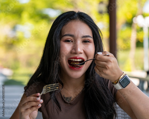 Thai Girl Smiles and Enjoys her food 