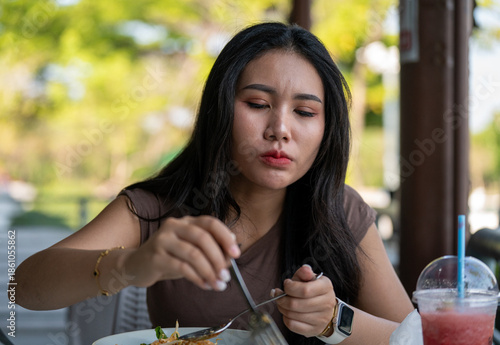 Thai Girl Smiles and Enjoys her food 
