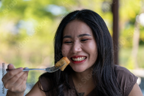 Thai Girl Smiles and Enjoys her food 