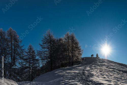 Silhouette of two men on mountain ridge, Alps mountains