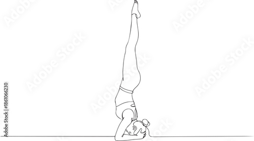 Woman doing yoga headstand in modern minimalist space with elegance