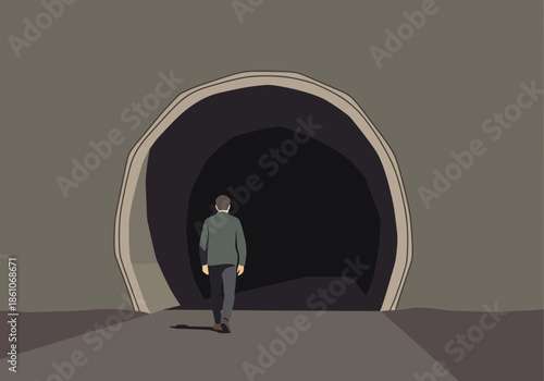 Person walks towards a dark tunnel entrance.
