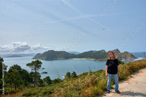 Senior woman enjoying the breathtaking views of the Cies Islands landscape.