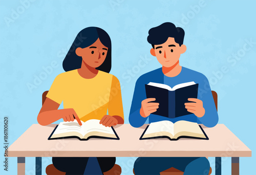Two people studying at a table with books open