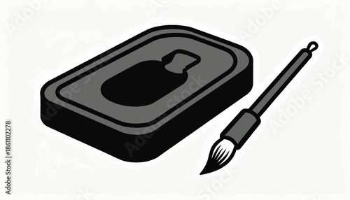 A black ink stone with a well and a brush with white bristles