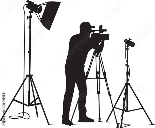 Black Silhouette of Cameraman Filming with Video Camera and Studio Lights