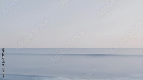 Serene ocean wave cresting in soft pastel light