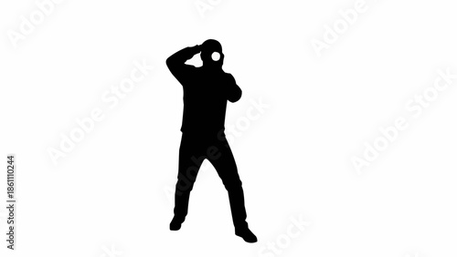 Silhouette of a person holding a camera and taking a photo.