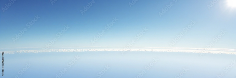 Obraz premium a serene and vast landscape with a clear distant horizon, the curved edge of the earth visible in the distance, set against a brilliant clear white sky with no clouds or obstructions, the atmosphere