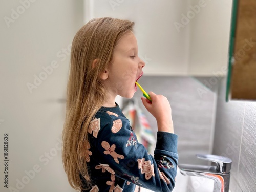 Small girl brushing her teeth