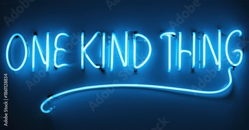 Bright blue neon sign displays text one kind thing. Dark background emphasizes glowing script, simple design. Modern aesthetic.