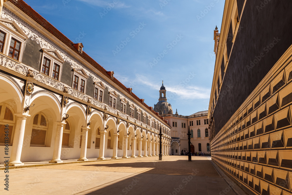 Fototapeta premium Historic Stallhof courtyard in Dresden, Germany, with arcaded Renaissance architecture and the womens church dome in the background. Iconic old town landmark reflecting Saxon history and culture
