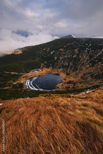 Autumn landscapes of the Karkonosze Mountains near Śnieżka, captured before winter. Dramatic sunrise and sunset light over ridges, valleys, and alpine scenery.