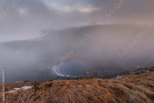 Autumn landscapes of the Karkonosze Mountains near Śnieżka, captured before winter. Dramatic sunrise and sunset light over ridges, valleys, and alpine scenery.