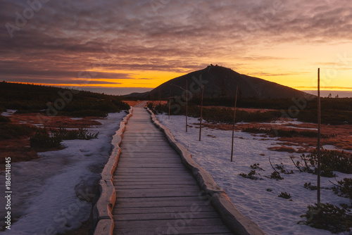 Autumn landscapes of the Karkonosze Mountains near Śnieżka, captured before winter. Dramatic sunrise and sunset light over ridges, valleys, and alpine scenery.