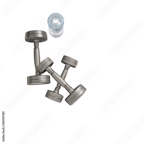 Small Weights and a Water Bottle on a Plain Background During Workout Prepara...
