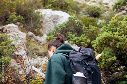 young pretty brunette girl hiking to waterfall, lifestyle people concept