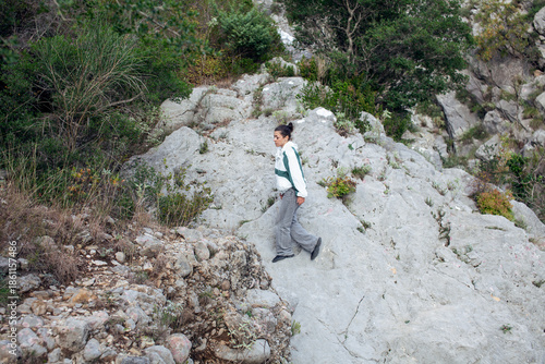 young pretty brunette girl hiking to waterfall, lifestyle people concept