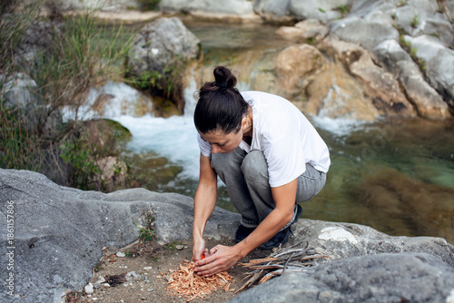 young pretty brunette girl hiking to waterfall, lifestyle people concept